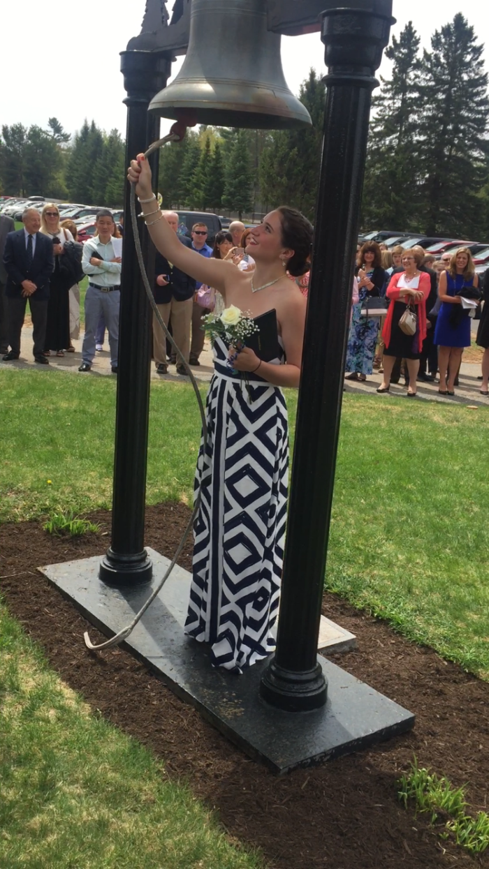 Cailey ringing the victory bell at graduation